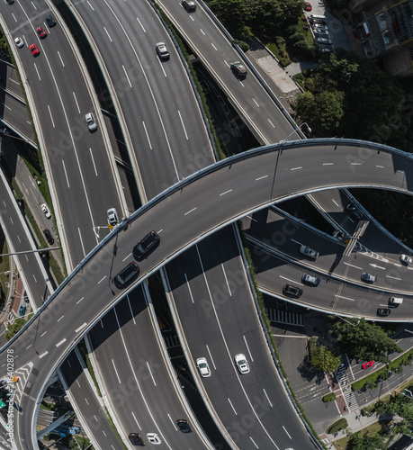 Aerial view of highway and overpass in city on sunny day