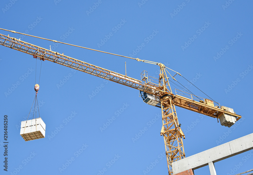 Tower crane works at the construction site Tower crane works at the construction site
