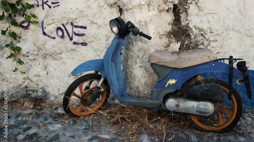 Old abandoned motorcycle lies on the streets of Granada, Spain.