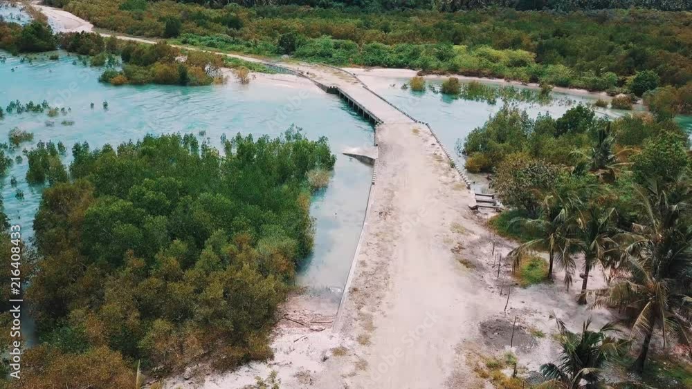 Aerial clip of a little bridge with a dirt road near Tambac, Philippines. Aerial clip of a little bridge with a dirt road near Tambac, Philippines.