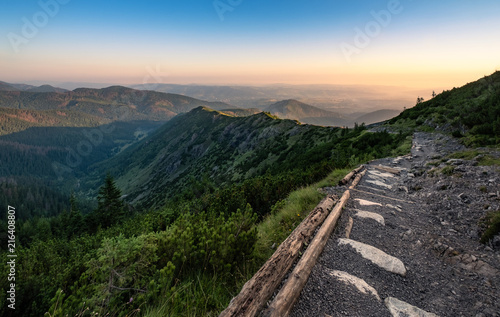 Scenic mountain view with mood sunrise and path at summer morning in Tatra National park, Poland