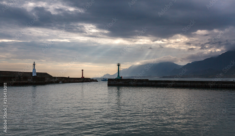 Peaceful Harbour, mountain island background with sunset and rays of sunlight streaming between the clouds - Chenggong Harbour, Taiwan