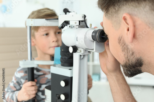 Fototapeta Naklejka Na Ścianę i Meble -  Ophthalmologist examining little boy in clinic