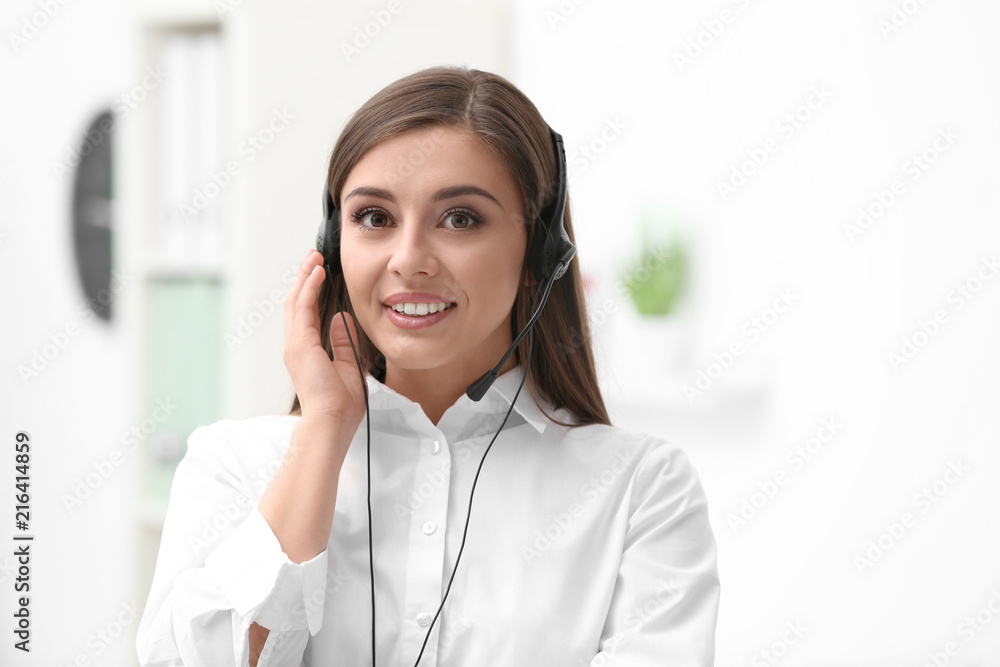 Young female receptionist with headset in office Young female receptionist with headset in office