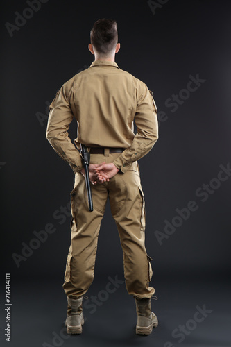 Male security guard in uniform on dark background
