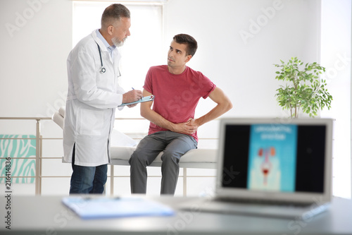 Fotografi Man with health problem visiting urologist at hospital