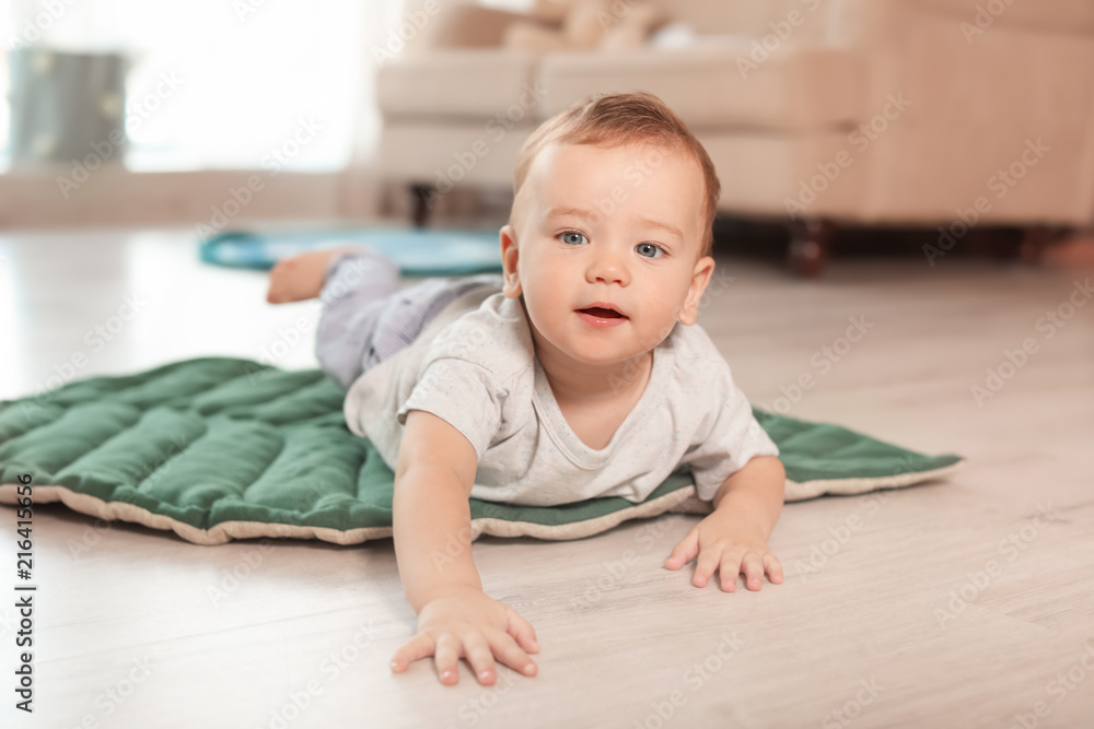 Adorable little baby crawling on floor at home Adorable little baby crawling on floor at home