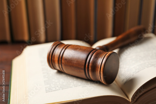 Wooden gavel and books on table, closeup. Law concept