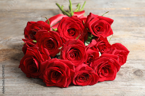 Beautiful red rose flowers on wooden background