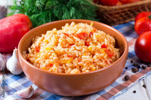 Bowl full of rice with tomatoes photo