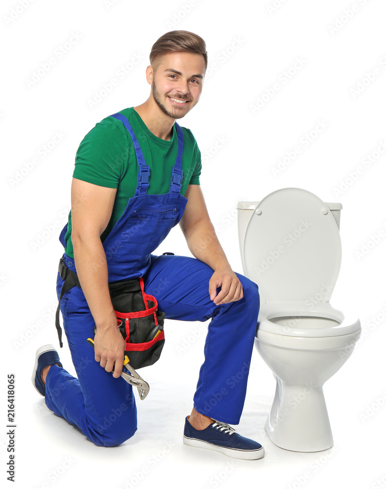 Young man working with toilet bowl, isolated on white Young man working with toilet bowl, isolated on white