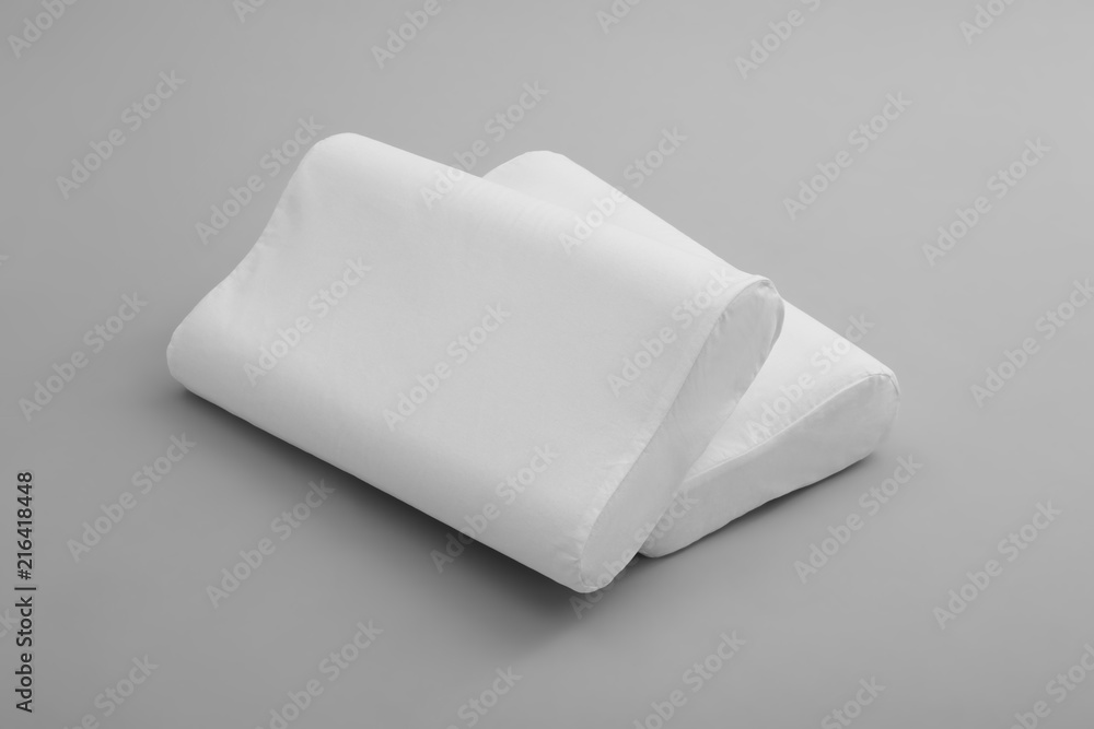 Clean soft orthopedic pillows on grey background Clean soft orthopedic pillows on grey background