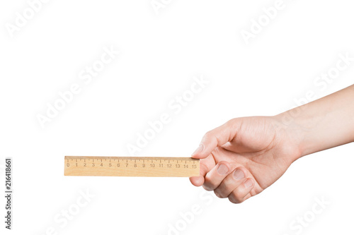 Hand holding wooden ruler, isolated on white background