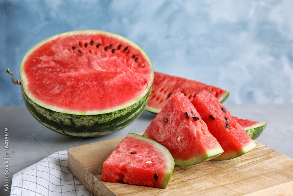 Wooden board with juicy watermelon slices on table Wooden board with juicy watermelon slices on table