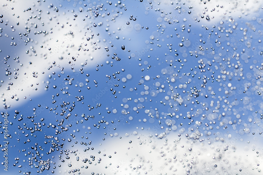 Close-up of water drops on glass surface as background Close-up of water drops on glass surface as background