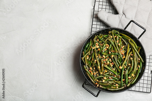 Yummy green beans with almonds in dish on table