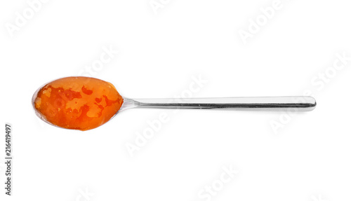 Spoon with tasty apricot jam on white background, top view