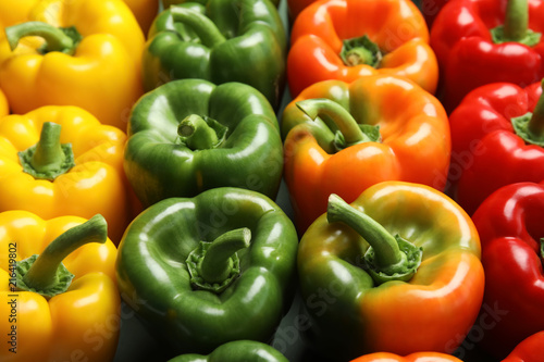 Colorful paprika peppers on grey background, closeup