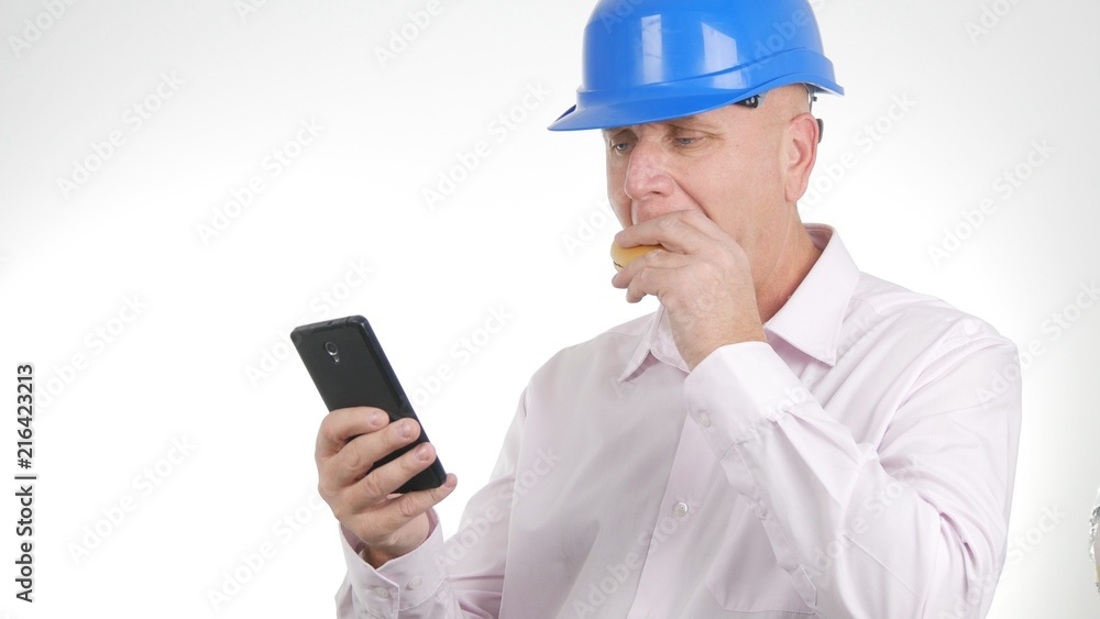 Engineer Image Eating a Sandwich and Text Using Mobile Phone