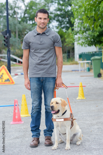 Fotografie Portrait of man with guide dog