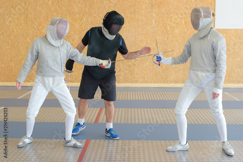 fencing practice with referee