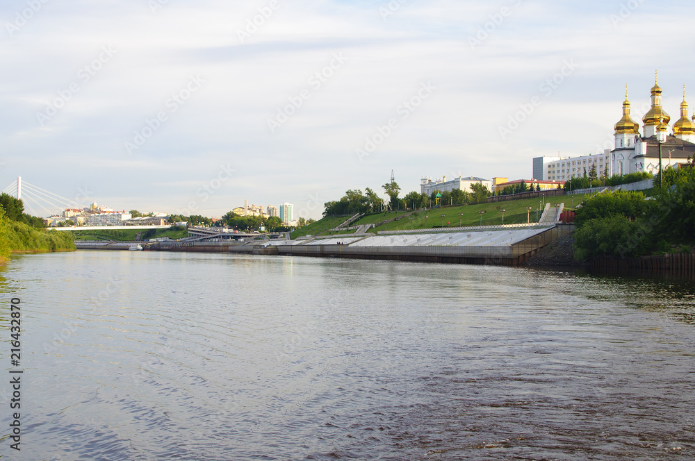 Fototapeta premium Tura River Embankment in Tyumen, Russia. Holy Trinity Monastery.