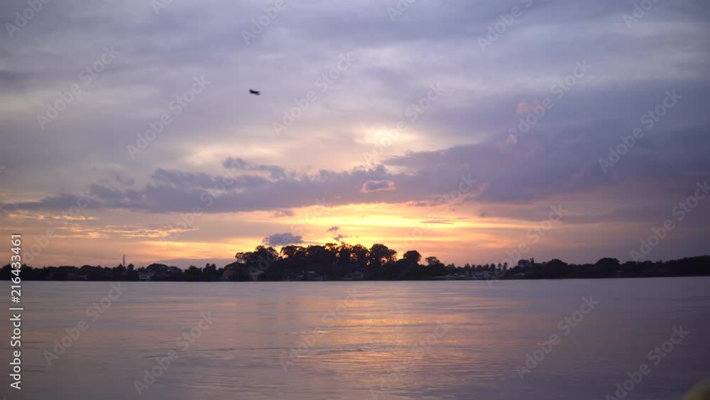 Natural landscape of Maekhong River is a muddy color during sunset at border line between Thailand and Lao,Asia. Shot image from Thailand side at Nongkhai province,Thailand. Natural landscape of Maekhong River is a muddy color during sunset at border line between Thailand and Lao,Asia. Shot image from Thailand side at Nongkhai province,Thailand.