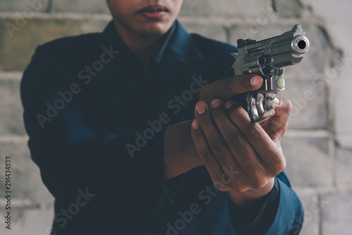 Businessman holding a gun to kill himself committed suicide because of despondent and despair in the office.