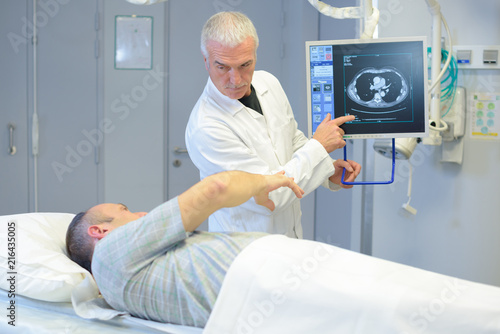 Doctor explaining image on screen to patient