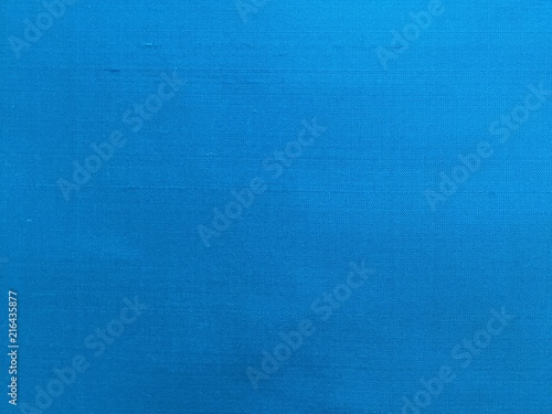 Woven texture silk fabric turquoise background  copy space.