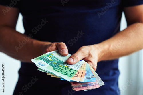 Wallpaper Mural Close up of male hands with money. Amount of the euro in cash banknotes Torontodigital.ca