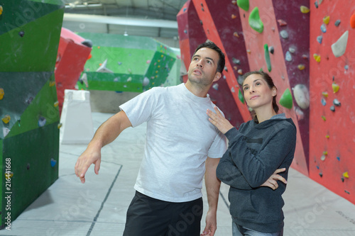 woman and man at climbing wall and training day © auremar