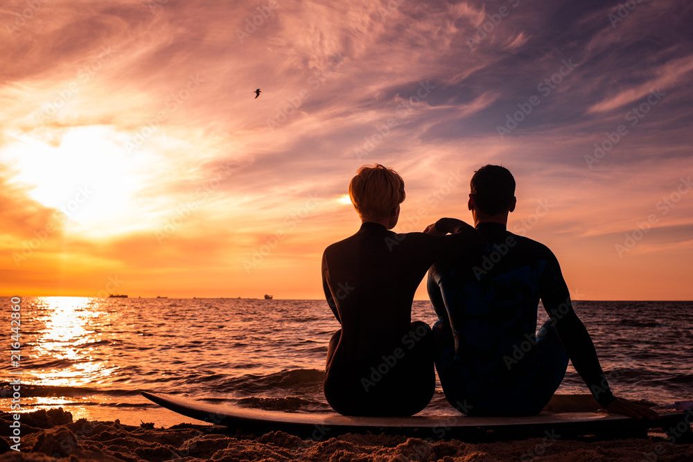 Sun surfer. A man is walking with a surf in his hands across the sea shore. Sun surfer. A man is walking with a surf in his hands across the sea shore.