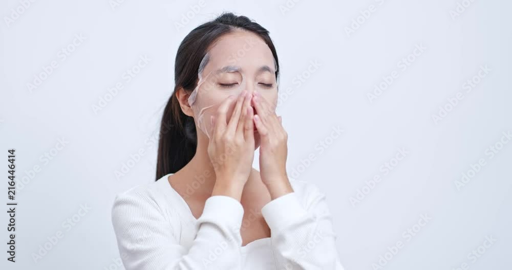 Woman apply face mask and massaging Woman apply face mask and massaging