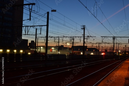 Nighttime photograph of railway tracks, taken shortly after sundown in Leuven, Belgium.