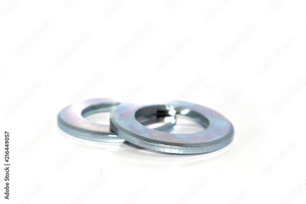 A couple of big industrial galvanized steel washers on white background A couple of big industrial galvanized steel washers on white background