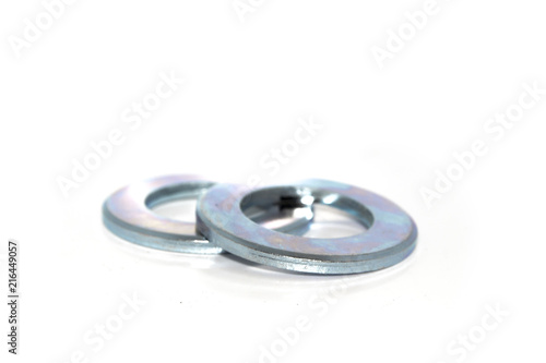 A couple of big industrial galvanized steel washers on white background