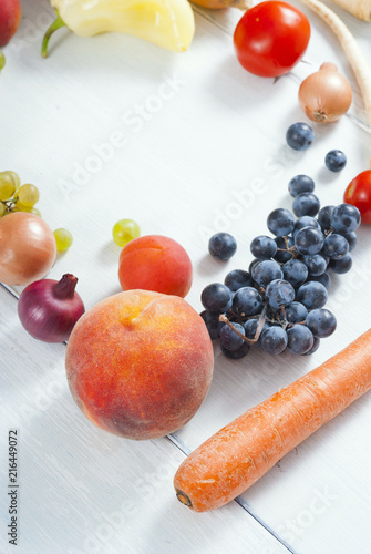 autumnal fruits and vegetables on white wooden table