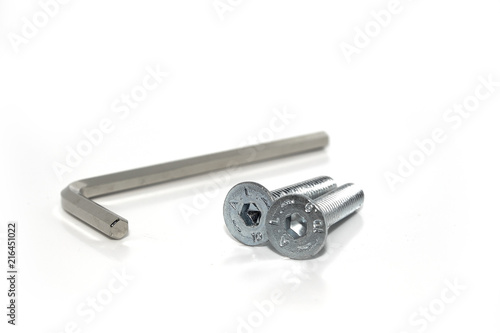 Single isolated Allen screw driver wrench with a couple of screws on white background