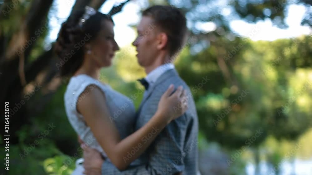 Beautiful bride and groom walking in the park before the wedding ceremony Beautiful bride and groom walking in the park before the wedding ceremony