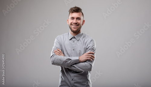 Happy confident man with folded arms photo