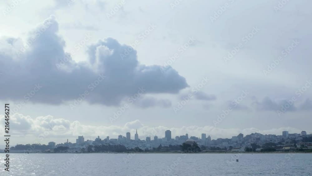 Time lapse of rain clouds moving over the San Francisco skyline. Taken from the pier at Crissey Field. Morning light, skyline silhouetted. Bay water with small waves in the foreground. Time lapse of rain clouds moving over the San Francisco skyline. Taken from the pier at Crissey Field. Morning light, skyline silhouetted. Bay water with small waves in the foreground.