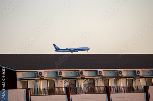 Osaka, Japan - August 4, 2018: ANA plane comes in low for landing at Itami Airport in Osaka photo