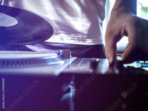 close up young dj playing modern music on professional equipment setup toned