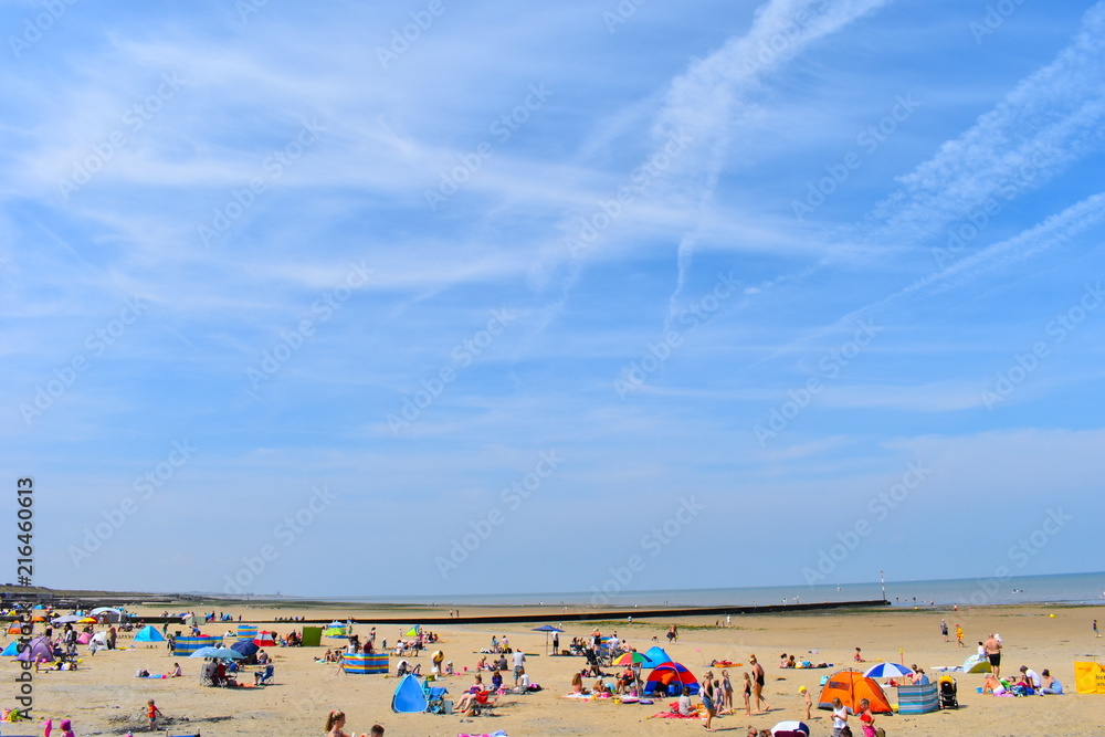 Minnis Bay beach packed with tourists and locals enjoying the sunshine. Birchington, Kent, England