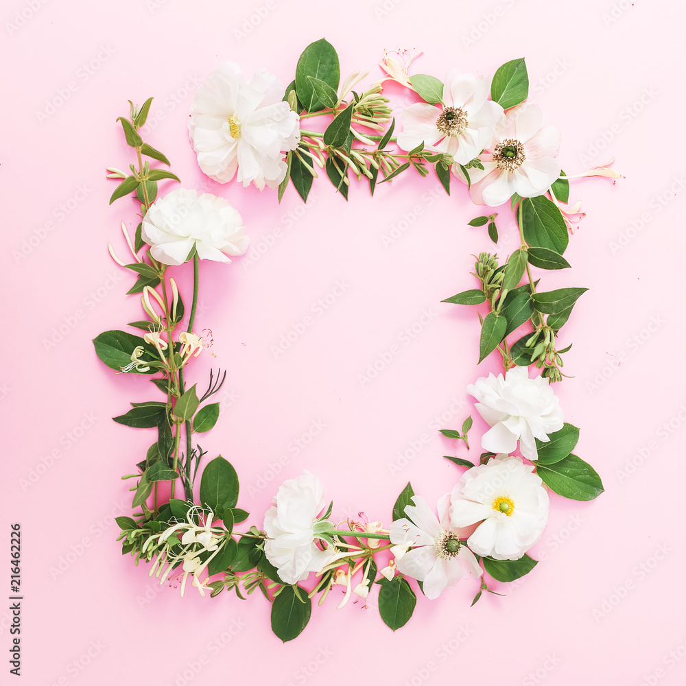 Frame of white flowers and leaves on pink pastel background. Flat lay, top view. Floral pattern Frame of white flowers and leaves on pink pastel background. Flat lay, top view. Floral pattern