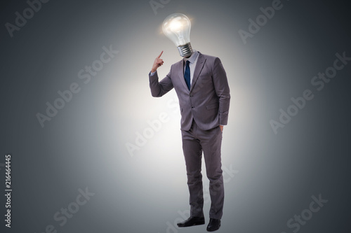 Businessman in bright idea concept with lightbulb head