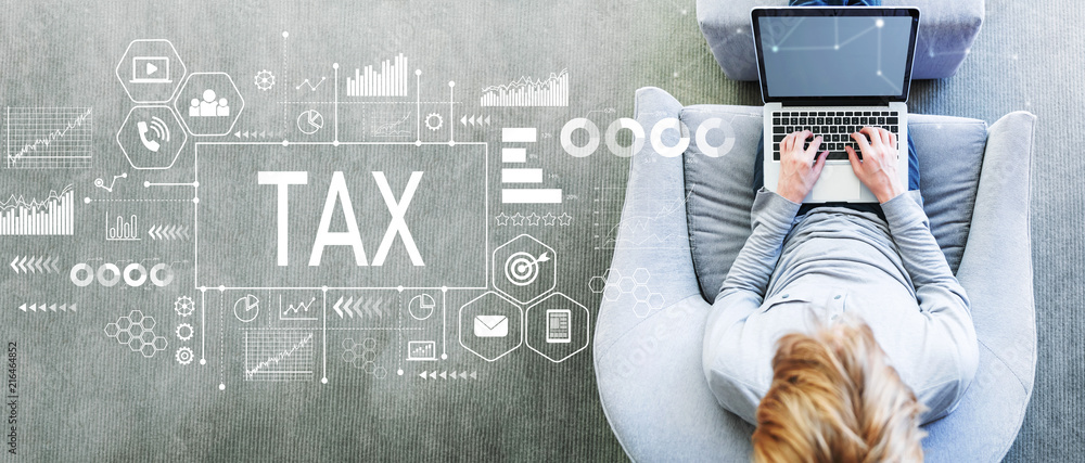 Tax with man using a laptop in a modern gray chair
