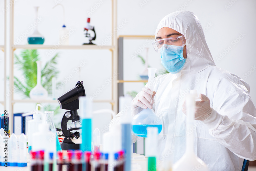 Young chemist student working in lab on chemicals Young chemist student working in lab on chemicals