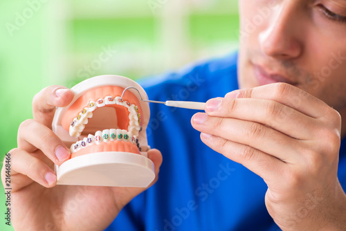 Man dentist working on new teeth implant 